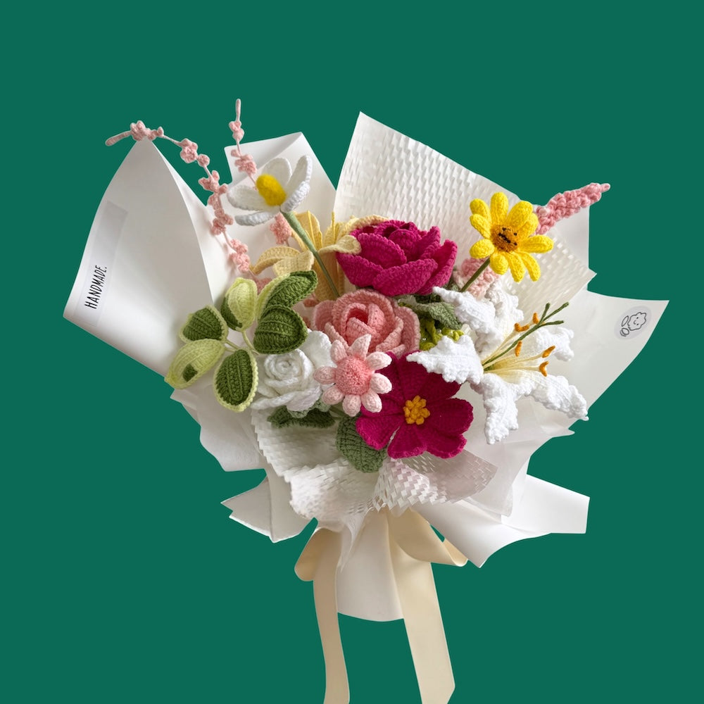 Colorful bouquet of flowers in a white paper cone on a green background